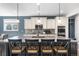 Bright kitchen features an island with bar seating and stainless steel appliances at 15565 E 115Th Ave, Commerce City, CO 80022