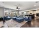 Open-concept living room boasts dark wood floors and seamlessly connects to the kitchen at 15565 E 115Th Ave, Commerce City, CO 80022