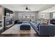 Bright living room featuring dark hardwood floors, fireplace, and ample seating at 15565 E 115Th Ave, Commerce City, CO 80022