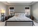 Main bedroom with tray ceiling, neutral decor, large bed, and windows that let in plenty of light at 15565 E 115Th Ave, Commerce City, CO 80022