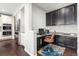 Home office space with custom cabinetry, granite countertops, and a comfortable leather chair at 15565 E 115Th Ave, Commerce City, CO 80022