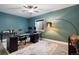 Stylish home office with two desks, modern lighting, and a bright accent wall, ideal for productivity at 15565 E 115Th Ave, Commerce City, CO 80022