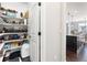 View of a walk-in pantry with shelving stocked with various food items and kitchen essentials at 15565 E 115Th Ave, Commerce City, CO 80022
