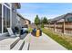 Comfortable patio space with outdoor seating and grill, perfect for relaxing and entertaining in your backyard at 15565 E 115Th Ave, Commerce City, CO 80022