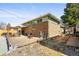 The backyard offers a covered patio, brick facade, and access to the upper level at 1173 Dallas St, Aurora, CO 80010