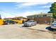 Exterior view with ample parking, wooden fence, covered patio and access to the upper level at 1173 Dallas St, Aurora, CO 80010