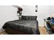 Bedroom with a dark colored bed and a skateboard on the wall at 1173 Dallas St, Aurora, CO 80010