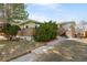 Home exterior with brick facade, mature landscaping, and a convenient walkway at 1173 Dallas St, Aurora, CO 80010