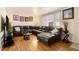 Cozy living room featuring a sectional couch, hardwood floors, and natural light at 1173 Dallas St, Aurora, CO 80010
