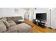 Living room with a sectional sofa, a glass coffee table and a mounted television at 1173 Dallas St, Aurora, CO 80010