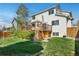 Backyard with a wooden deck, lush landscaping, and well-manicured lawn at 5929 Dunraven Way, Golden, CO 80403