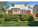 Backyard with a wooden deck, lush green bushes, and well-manicured lawn at 5929 Dunraven Way, Golden, CO 80403