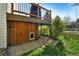 Exterior view of backyard with under-deck storage, rock landscaping, and grass at 5929 Dunraven Way, Golden, CO 80403