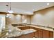 Basement bar area featuring a marble countertop, custom cabinetry, and pendant lighting at 5929 Dunraven Way, Golden, CO 80403