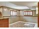 Finished basement showcasing windows with shutters, neutral paint, and a granite countertop wet bar at 5929 Dunraven Way, Golden, CO 80403