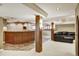 Finished basement featuring a bar area, decorative lighting, and comfortable seating at 5929 Dunraven Way, Golden, CO 80403