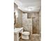 Bathroom featuring a tiled shower, pedestal sink, and modern lighting at 5929 Dunraven Way, Golden, CO 80403
