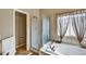 Bathroom featuring a soaking tub, tile flooring, and separate glass enclosed shower at 5929 Dunraven Way, Golden, CO 80403