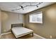Cozy bedroom with a minimalist bed frame and natural light from the window at 5929 Dunraven Way, Golden, CO 80403