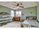 Cozy bedroom with a ceiling fan, dresser, and shelving unit at 5929 Dunraven Way, Golden, CO 80403