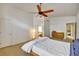 Bedroom featuring a bed, dresser, ceiling fan, and an ensuite bath at 5929 Dunraven Way, Golden, CO 80403