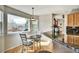 Cozy breakfast nook with mountain views, hardwood floors and bright windows, adjacent to the kitchen bar at 5929 Dunraven Way, Golden, CO 80403