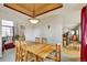 Inviting dining room featuring a large wooden table, natural light, and views to adjacent rooms at 5929 Dunraven Way, Golden, CO 80403