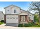Charming two-story home with a brick-accented facade, a well-manicured lawn, and an attached two-car garage at 5929 Dunraven Way, Golden, CO 80403