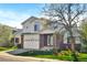 Charming two-story home with a brick-accented facade, a well-manicured lawn, and an attached two-car garage at 5929 Dunraven Way, Golden, CO 80403