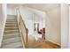 Bright foyer featuring hardwood floors, a staircase, and an open view to the formal living room at 5929 Dunraven Way, Golden, CO 80403