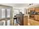 Spacious kitchen featuring a breakfast bar with granite countertops, stainless steel appliances and hardwood flooring at 5929 Dunraven Way, Golden, CO 80403