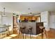 Open kitchen with hardwood floors, breakfast bar seating, and stainless steel appliances, adjacent to the dining area at 5929 Dunraven Way, Golden, CO 80403