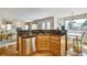 Open-concept kitchen featuring a breakfast bar with granite countertops and stainless steel appliances at 5929 Dunraven Way, Golden, CO 80403