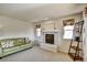 Bright living room showcasing a fireplace, large windows, neutral carpeting, and comfortable seating at 5929 Dunraven Way, Golden, CO 80403