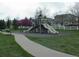 Community playground with slides, swings, and green space in a residential neighborhood at 5929 Dunraven Way, Golden, CO 80403