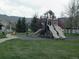 Community playground with slides, swings, and green space in a residential neighborhood at 5929 Dunraven Way, Golden, CO 80403