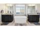 Well-lit bathroom featuring a soaking tub, dual vanities, and sleek countertops for a luxurious feel at 18809 W 92Nd Dr, Arvada, CO 80007