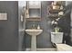 This powder room features a pedestal sink and decorative accents, perfect for guests at 18809 W 92Nd Dr, Arvada, CO 80007