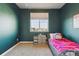 Cozy bedroom with a large window, closet, and a comfortable bed for a relaxing retreat at 18809 W 92Nd Dr, Arvada, CO 80007