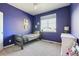 This bedroom features a bright blue wall and a window that provides ample natural light at 18809 W 92Nd Dr, Arvada, CO 80007