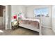 Bright bedroom featuring a comfy bed, a window with mountain views, and light-colored walls at 18809 W 92Nd Dr, Arvada, CO 80007
