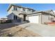 Beautiful two-story home featuring a gray exterior, a two-car garage, and a concrete driveway at 18809 W 92Nd Dr, Arvada, CO 80007