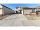 Contemporary home showcasing a brick and siding exterior with a long driveway at 18809 W 92Nd Dr, Arvada, CO 80007