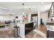 Open kitchen concept featuring stainless steel appliances, granite countertops and direct view to the living room at 18809 W 92Nd Dr, Arvada, CO 80007