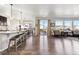 Bright, open concept living room, dining, and kitchen area with hardwood floors and natural light at 18809 W 92Nd Dr, Arvada, CO 80007