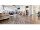 Open concept living room featuring hardwood floors, a fireplace, and comfortable seating at 18809 W 92Nd Dr, Arvada, CO 80007