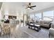 Open-concept living area featuring hardwood floors, view to kitchen and large windows for lots of light at 18809 W 92Nd Dr, Arvada, CO 80007
