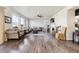 Bright and airy living room with large windows, hardwood floors, and a cozy fireplace at 18809 W 92Nd Dr, Arvada, CO 80007