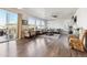 Bright, open living room with hardwood floors, large windows, and a sliding door to a deck at 18809 W 92Nd Dr, Arvada, CO 80007