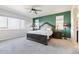 Spacious main bedroom featuring a ceiling fan, neutral carpet, and a decorative dark wood bed frame at 18809 W 92Nd Dr, Arvada, CO 80007